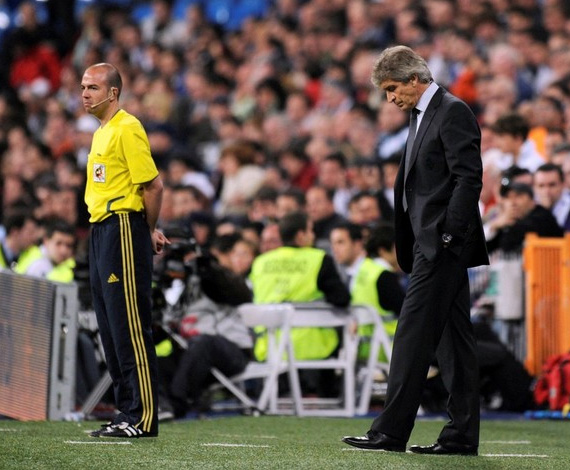 Real Madrid Chilian coach Manuel Pellegrini (R) reacts during the 'El Clasico' Spanish League football match Real Madrid against Barcelona at the Santiago Bernabeu stadium in Madrid on April 10, 2010. Barcelona won 0-2.