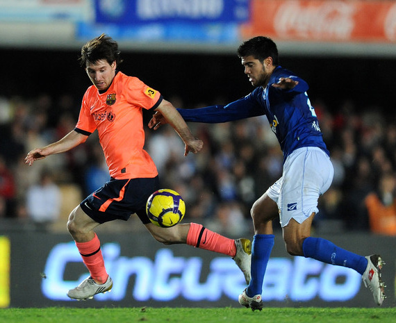 Lionel Messi (L) of FC Barcelona duels for the ball with Aythami of Xerez during the La Liga match between Barcelona and Xerez at Estadio Municipal de Chapin on December 2, 2009 in Jerez de la Frontera, Spain. Barcelona won the match 2-0.