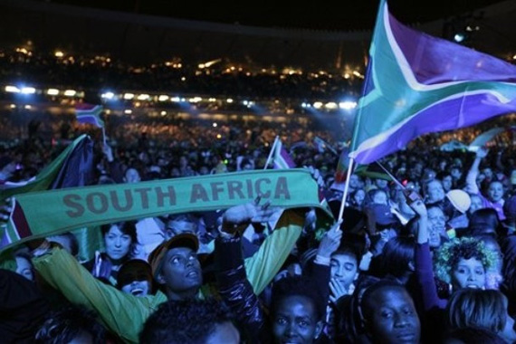 Spectators wave their flags during the opening concert for the soccer World Cup at Orlando stadium in Soweto, South Africa, Thursday, June 10, 2010. The Soccer World Cup kicks off on Friday, June 11.